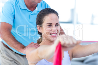 Therapist massaging cheerful pregnant woman