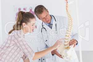 Doctor explaining anatomical spine to his patient