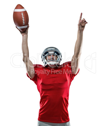 American football player with holding ball arms raised