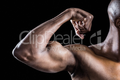 Cropped image of muscular man flexing muscles
