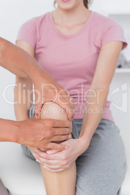 Doctor examining his patient knee