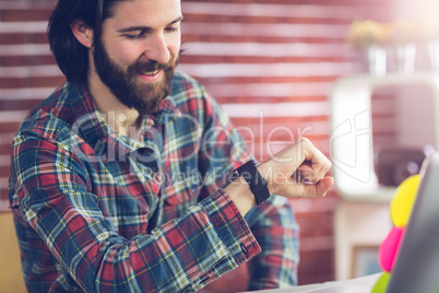 Smiling businessman checking time