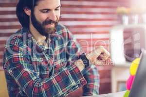 Smiling businessman checking time