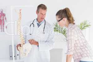 Doctor explaining anatomical spine to his patient