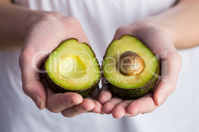 Woman showing fresh avocado