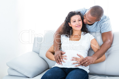 Man and woman touching pregnant belly