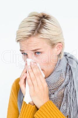 Close up of woman blowing her nose