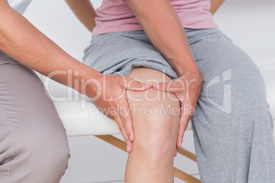 Doctor examining his patient knee