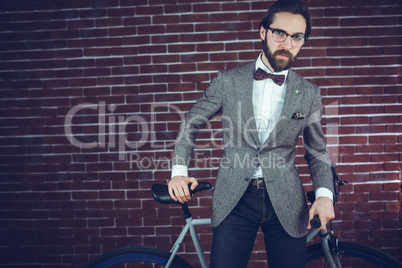 Portrait of fashionable man with bicycle