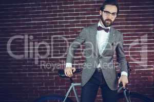 Portrait of fashionable man with bicycle