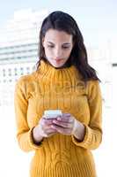 Focused woman using her smartphone
