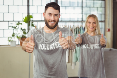 Happy smiling volunteers giving thumbs