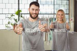 Happy smiling volunteers giving thumbs