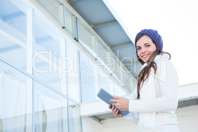 Happy brunette using tablet pc