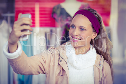 Smiling woman taking selfies