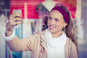Smiling woman taking selfies