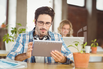 Businessman working on digital tablet in bright office