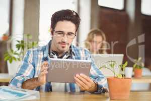 Businessman working on digital tablet in bright office