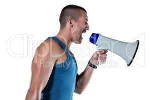 Angry male trainer yelling through megaphone