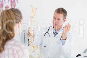 Doctor showing his patient a spine model