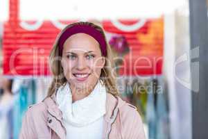 Smiling woman in front of sale sign
