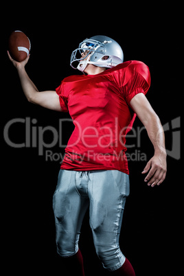 American football player holding ball