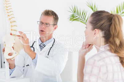 Doctor explaining anatomical spine to his patient
