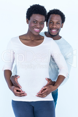 Portrait of husband embracing wife while standing