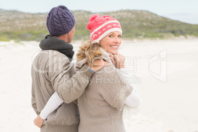 Happy couple embracing by the shore