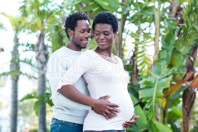 Husband embracing pregnant wife