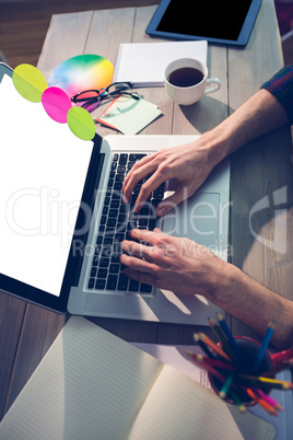 Cropped image of graphic designer using laptop