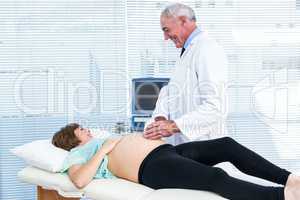 Doctor showing ultrasound monitor to woman