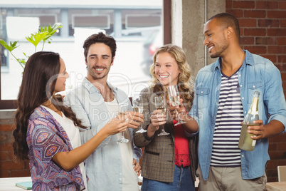 Business people toasting with champagne in office