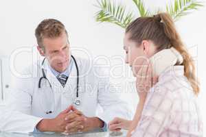 Doctor talking to patient wearing neck brace