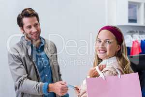 Smiling woman getting back credit card