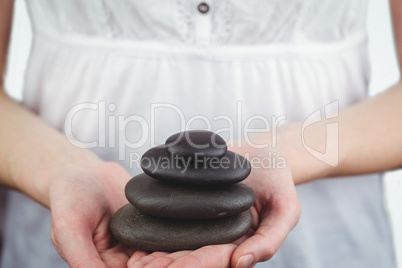 Woman holding black stones