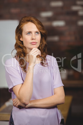 Thoughtful young woman in office