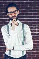 Portrait of smiling hipster with hand on chin