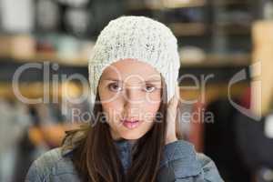 Serious pretty brunette looking at camera with winter clothes