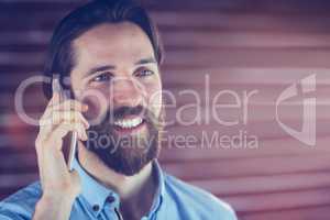 Portrait of smiling hipster using cellphone