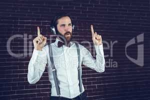 Handsome man looking away while listening music