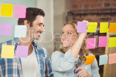 Happy businesswoman looking at colleague in office