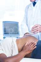 Doctor performing ultrasound on pregnant woman