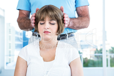Close-up of male therapist performing reiki over woman