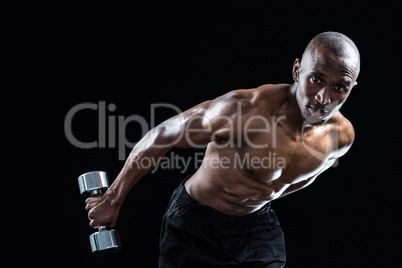 Portrait of muscular man bending while exercising