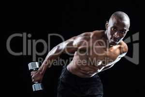 Portrait of muscular man bending while exercising