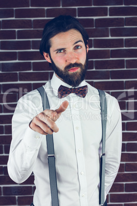 Portrait of confident hipster pointing finger