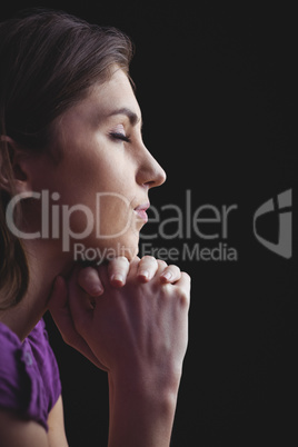 Woman praying with hands together