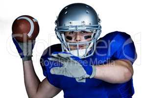 Portrait  of American football player with ball playing