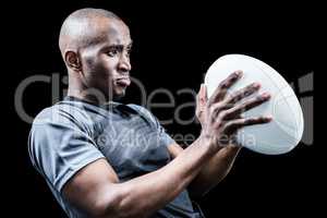 Rugby player looking away while throwing ball